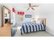 Bright bedroom features twin beds with blue and white striped bedding, creating a playful and inviting space for children at 253 Aldridge Ln, Davenport, FL 33897