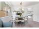 Elegant dining area with a glass table, stylish chairs, and an abundance of natural light, perfect for meals at 253 Aldridge Ln, Davenport, FL 33897