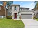 Inviting two-story home featuring a neutral color palette, well-kept lawn, and two car garage at 253 Aldridge Ln, Davenport, FL 33897
