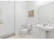 Half bathroom featuring a pedestal sink, a toilet, and a door at 253 Aldridge Ln, Davenport, FL 33897