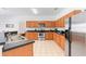 Bright kitchen with stainless steel appliances, dark countertop, and tile flooring at 253 Aldridge Ln, Davenport, FL 33897