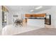 Bright kitchen features oak cabinets, black countertops, stainless steel appliances, and a dining area, perfect for everyday meals at 253 Aldridge Ln, Davenport, FL 33897