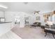 Spacious living area with connecting rooms offering flexibility, neutral carpet and a ceiling fan at 253 Aldridge Ln, Davenport, FL 33897