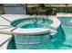 Hot tub with tile surround spilling into the pool, perfect for relaxation and entertainment at 253 Aldridge Ln, Davenport, FL 33897