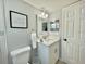 Cozy bathroom featuring a stylish vanity with modern fixtures and a decorative mirror at 2714 Rio Grande Trl # 2714, Kissimmee, FL 34741