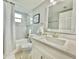 Bright bathroom featuring modern fixtures, a shower, and a white vanity with a framed mirror at 2714 Rio Grande Trl # 2714, Kissimmee, FL 34741