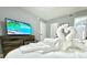 Comfortable bedroom with a swan towel decoration on the bed and a large TV at 2714 Rio Grande Trl # 2714, Kissimmee, FL 34741