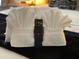 Close-up of towel art and a remote control on a bed with a black blanket at 2714 Rio Grande Trl # 2714, Kissimmee, FL 34741