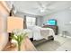 Inviting bedroom with modern decor, ceiling fan, and a comfortable bed with decorative pillows at 2714 Rio Grande Trl # 2714, Kissimmee, FL 34741