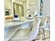Kitchen bar featuring a counter with stainless steel appliances and modern stools at 2714 Rio Grande Trl # 2714, Kissimmee, FL 34741