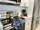 Modern kitchen with stainless steel appliances, white cabinets, and ample counter space at 2714 Rio Grande Trl # 2714, Kissimmee, FL 34741