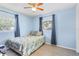 Cozy bedroom featuring light blue walls, a ceiling fan, and bright natural light at 3122 Eleuthera Ln, Orlando, FL 32827