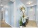Charming entryway with terrazzo flooring, light blue walls and decorative console table at 3122 Eleuthera Ln, Orlando, FL 32827
