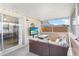 Covered patio with wicker furniture seating area and mounted television at 3122 Eleuthera Ln, Orlando, FL 32827