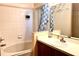 Bathroom featuring a tub/shower combination with blue shower curtain, and a wood vanity at 314 Saddle Ridge Dr, Davenport, FL 33896