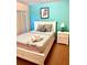 Bedroom featuring a queen-size bed, white nightstand and a bright teal wall at 314 Saddle Ridge Dr, Davenport, FL 33896