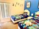 Fun ' bedroom with twin beds and playful Toy Story bedding at 314 Saddle Ridge Dr, Davenport, FL 33896