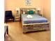Cozy bedroom featuring a queen bed with wood frame, and two nightstands with lamps at 314 Saddle Ridge Dr, Davenport, FL 33896