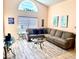 Spacious living room featuring a comfortable sectional sofa, glass coffee table, and stylish decor at 314 Saddle Ridge Dr, Davenport, FL 33896