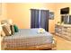 Comfortable bedroom with a rustic wood bed frame, soft blue bedding, and light peach colored walls at 314 Saddle Ridge Dr, Davenport, FL 33896
