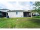 Spacious backyard with lush grass and a view of the screened patio at 3298 Stratton Cir, Kissimmee, FL 34744