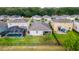 Aerial view of backyard featuring a pool with screened enclosure and black metal fence at 3298 Stratton Cir, Kissimmee, FL 34744