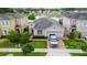 Charming single-Gathering home features manicured lawn and a brick driveway, set against a serene pond backdrop at 3298 Stratton Cir, Kissimmee, FL 34744