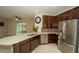 Modern kitchen with stainless steel appliances, tile flooring, stone countertops, and dark wood cabinetry at 3298 Stratton Cir, Kissimmee, FL 34744