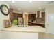 Modern kitchen featuring quartz countertops, stainless steel appliances, and dark wood cabinets at 3298 Stratton Cir, Kissimmee, FL 34744