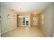 Open-concept living room featuring tile flooring, neutral walls, and double doors with lots of natural light at 3298 Stratton Cir, Kissimmee, FL 34744