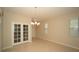 Spacious dining room features tile flooring, and double doors with lots of natural light at 3298 Stratton Cir, Kissimmee, FL 34744