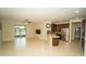 Open-concept living space with tile flooring, island kitchen, and sliding glass doors to outdoor patio at 3298 Stratton Cir, Kissimmee, FL 34744