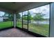 Relaxing screened patio with brick pavers and a view of the backyard and pond at 3298 Stratton Cir, Kissimmee, FL 34744