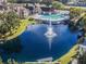 Beautiful aerial view of the community pool, pond with fountain, and surrounding lush landscaping at 4301 Lizshire Ln # 306, Orlando, FL 32822