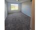 Bright bedroom features neutral walls, a window, and comfortable carpeting at 4301 Lizshire Ln # 306, Orlando, FL 32822