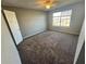 Bedroom with window, fan, closet and neutral carpet at 4301 Lizshire Ln # 306, Orlando, FL 32822