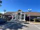 Community clubhouse featuring lush landscaping and an inviting entrance at 4301 Lizshire Ln # 306, Orlando, FL 32822