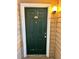 Green front door with gold accents in a well-maintained condo community at 4301 Lizshire Ln # 306, Orlando, FL 32822
