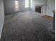 Large carpeted living room with fireplace, exterior access and neutral walls at 4301 Lizshire Ln # 306, Orlando, FL 32822