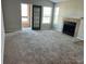 Spacious living room with fireplace, plush carpeting and access to outdoor balcony at 4301 Lizshire Ln # 306, Orlando, FL 32822