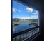 Scenic view from the balcony overlooking a tranquil pond and community buildings at 4301 Lizshire Ln # 306, Orlando, FL 32822