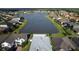 Areal view of home overlooking tranquil lake and lush green surroundings in a serene neighborhood at 4337 Summer Breeze Way, Kissimmee, FL 34744
