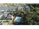 Areal view of homes in a quiet neighborhood with a community pool surrounded by lush trees at 4337 Summer Breeze Way, Kissimmee, FL 34744