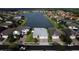 Aerial view of a neighborhood with a lake and well-maintained homes at 4337 Summer Breeze Way, Kissimmee, FL 34744