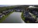 Scenic aerial view showcasing a community with a large pond and well-maintained homes at 4337 Summer Breeze Way, Kissimmee, FL 34744