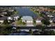 Overhead view of a home with a pond, mature landscaping, and a two-car garage at 4337 Summer Breeze Way, Kissimmee, FL 34744