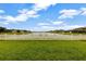 Beautiful backyard with a white picket fence and a serene lake view at 4337 Summer Breeze Way, Kissimmee, FL 34744