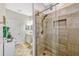 Bathroom boasts a tiled walk-in shower with glass doors and a vanity sink at 4337 Summer Breeze Way, Kissimmee, FL 34744