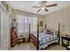 Bedroom with a four-poster bed, ceiling fan, and large window with sheer curtains at 4337 Summer Breeze Way, Kissimmee, FL 34744