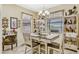 Dining area features a chandelier, bright windows, and decorative accents at 4337 Summer Breeze Way, Kissimmee, FL 34744